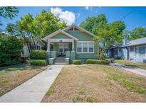 Charming green craftsman-style home with a landscaped front yard and welcoming porch at 739 Park Hill Ave, Lakeland, FL 33801