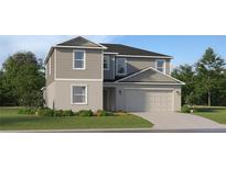 Traditional two-story home with a two-car garage, manicured lawn, and simple landscaping at 1145 Hour Glass Rd, Lakeland, FL 33801