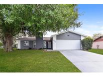 Charming single-Gathering home featuring a mature tree and a well-maintained front lawn at 248 Lake Thomas Dr, Winter Haven, FL 33880
