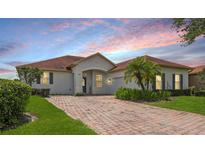 Charming single-story home featuring a well-maintained lawn, brick driveway, and inviting entrance at 448 Sorrento Rd, Kissimmee, FL 34759