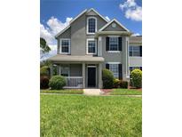 Charming two-story home with a covered front porch, fresh landscaping, and a well-maintained lawn at 9053 Lee Vista Blvd # 1405, Orlando, FL 32829
