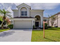 Charming two-story home with a well-manicured lawn, two car garage and elegant architectural details at 4444 Withrowwood Ct, Orlando, FL 32837