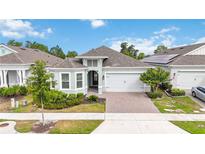 Charming single-story home with a two-car garage, lush landscaping, and a welcoming front entrance at 2132 Limestone Trl, Kissimmee, FL 34747