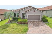 Charming single-Gathering home with a well-manicured lawn and paved driveway at 4235 Prima Lago Dr, Lakeland, FL 33810