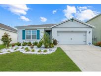Charming single-story home featuring a well-manicured lawn and bright blue shutters against a beautiful blue sky at 5934 Shingle Creek Rd, Lakeland, FL 33811