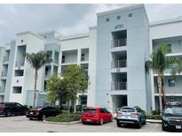 Modern apartment building with multiple stories, balconies and well-maintained landscaping at 4751 Clock Tower Dr # 307, Kissimmee, FL 34746