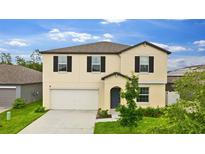 Beautiful two-story home with a well-maintained lawn and a spacious driveway at 2175 Old Mining Rd, Lakeland, FL 33801