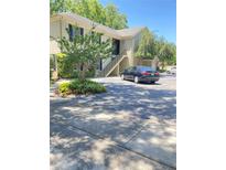 Inviting two-story condo building with black shutters, mature landscaping, and convenient parking spaces at 223 Windsor St # 6, Lakeland, FL 33803