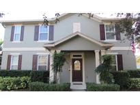 Charming two-story home featuring a well-manicured front yard and a welcoming front porch at 6832 Thornhill Cir, Windermere, FL 34786