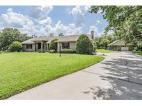 Sprawling single story home with lush green lawn, mature trees and separate garage at 2925 Deerbrook Dr, Lakeland, FL 33811