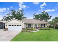 Charming single-story home featuring a well-manicured lawn, attached two-car garage and inviting front porch at 93 Bream St, Haines City, FL 33844