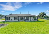 Charming single-story home with a well-manicured lawn and black trim windows at 2151 Groveglen S Ln, Lakeland, FL 33813