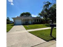 Charming single-story home featuring a well-manicured lawn and attached garage at 3802 Bryston Dr, Orlando, FL 32822