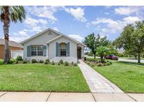 Charming single-story home featuring a beautifully landscaped front yard and a welcoming walkway at 3321 Pintello Ave, New Smyrna Beach, FL 32168