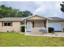 Charming single-story home features a well-maintained front yard and a welcoming covered entrance at 8386 Sw 105Th Pl, Ocala, FL 34481