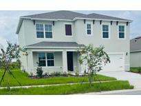 Charming two-story home with a manicured lawn and a two-car garage, inviting and well-maintained at 5543 Siltstone St, Lakeland, FL 33811