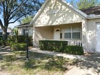 Charming single-story home featuring a brick facade, manicured landscaping, and a welcoming front porch at 9859 Sw 97Th St, Ocala, FL 34481