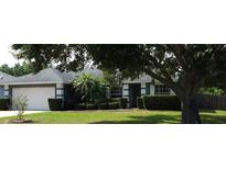 Charming single-story home featuring well-manicured landscaping and an attached two-car garage at 2509 Montecito Ave, Eustis, FL 32726