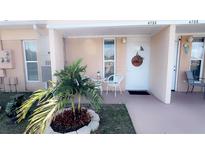 Charming front porch with a welcome wreath and seating area for relaxing at 4733 Club Cir, Lakeshore, FL 33854