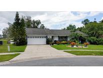 Charming single-story home features a well-manicured front yard and a two-car garage at 7607 Benji Ridge Trl, Kissimmee, FL 34747
