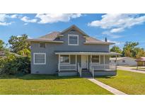 Inviting two-story home with a classic porch and well-maintained grassy front yard at 1048 W Lime St, Lakeland, FL 33815