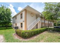 Inviting condo building with manicured landscaping and a white stairwell, offering convenient access to upper-level units at 946 15Th St # 202, Daytona Beach, FL 32117