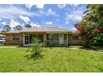 Charming single-story brick home with a well-maintained lawn and front porch at 5455 Pinetrail Way, Orlando, FL 32822