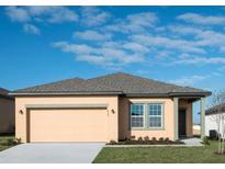 Charming single-story home featuring a neutral color scheme, a two-car garage and a well-manicured lawn at 3079 Daffodil Dr, Lake Hamilton, FL 33851