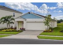 Charming single-Gathering home with a two-car garage, green lawn, and well-maintained landscaping at 762 Ambleside Dr, Haines City, FL 33844