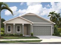 Charming single-story home featuring a two-car garage, covered porch, and well-manicured lawn at 5728 Haystack Drive, St Cloud, FL 34771