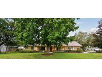 Charming single-story home with a well-maintained lawn and mature trees offering shade at 6642 Parson Brown Dr, Orlando, FL 32819