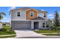 Charming two-story home with a well-manicured lawn and attached two-car garage at 1229 Tidal St, Haines City, FL 33844