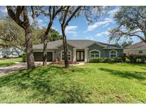 Charming single-story home with well-maintained lawn, colorful flowerbeds, and inviting curb appeal at 1610 Sherwood Lakes Blvd, Lakeland, FL 33809