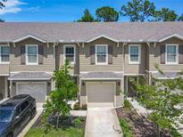 View of townhomes featuring attached garages, neutral colors, and well-maintained landscaping at 67 Bella Oaks Dr, Port Orange, FL 32129