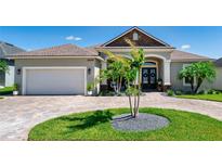 Beautiful home exterior with a paver driveway, lush lawn, and a charming front entry at 3249 Pearly Dr, Lakeland, FL 33812