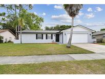 Charming single-story home with a well-manicured lawn and a two-car garage at 446 Eagle Cir, Casselberry, FL 32707