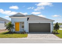 Charming one-story home features a two-car garage, bright yellow front door, and well-manicured landscaping at 9619 Sw 62Nd Ct, Ocala, FL 34476