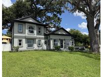 Stunning two-story home boasts a well-manicured lawn and a modern, gray color scheme at 808 Edgewater Dr, Orlando, FL 32804