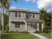 Charming two-story home with gray siding, a cozy front porch, and lush landscaping on a sunny day at 2359 Zuni Road, St Cloud, FL 34771