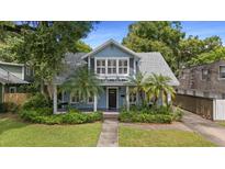 Charming light-blue two-story home with inviting front porch and lush landscaping at 530 S Eola Dr, Orlando, FL 32801
