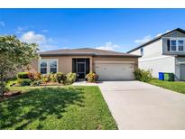 Charming single-story home featuring a well-manicured lawn, a two car garage and a cozy screened front porch at 4710 Osprey Way, Winter Haven, FL 33881