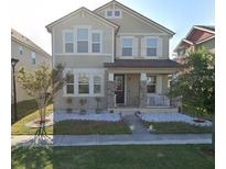 Charming two-story home featuring a well-maintained lawn and inviting front porch at 1704 Felicity Ln, Kissimmee, FL 34744