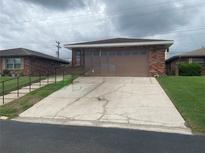 Cozy single-story home featuring brick facade, attached garage, and a convenient driveway at 661 Lake Carolyn Cir, Lakeland, FL 33813