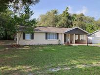 Charming single story home featuring a spacious front yard and a covered porch at 309 Sunnyside Ln, Debary, FL 32713