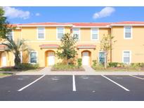 Inviting two-story townhome with a terracotta roof and parking spaces at 3020 Red Ginger Rd, Kissimmee, FL 34747