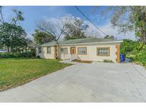 Charming single-story home with a well-manicured lawn and spacious driveway at 1039 W 12Th St, Lakeland, FL 33805