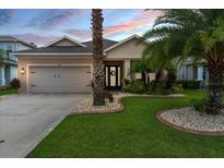 Two-story house with a landscaped lawn and a two-car garage at 702 Victory Ln, Port Orange, FL 32128