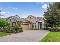 Single-story home with a two-car garage and landscaped yard at 210 Brookgreen Way, Deland, FL 32724