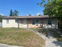 Charming single-story home featuring stucco siding, a front porch, and a well-maintained yard on a sunny day at 1110 Deltona Blvd, Deltona, FL 32725