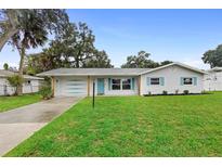 Charming ranch home with freshly painted exterior and landscaped lawn at 1412 Ruthbern Rd, Daytona Beach, FL 32114